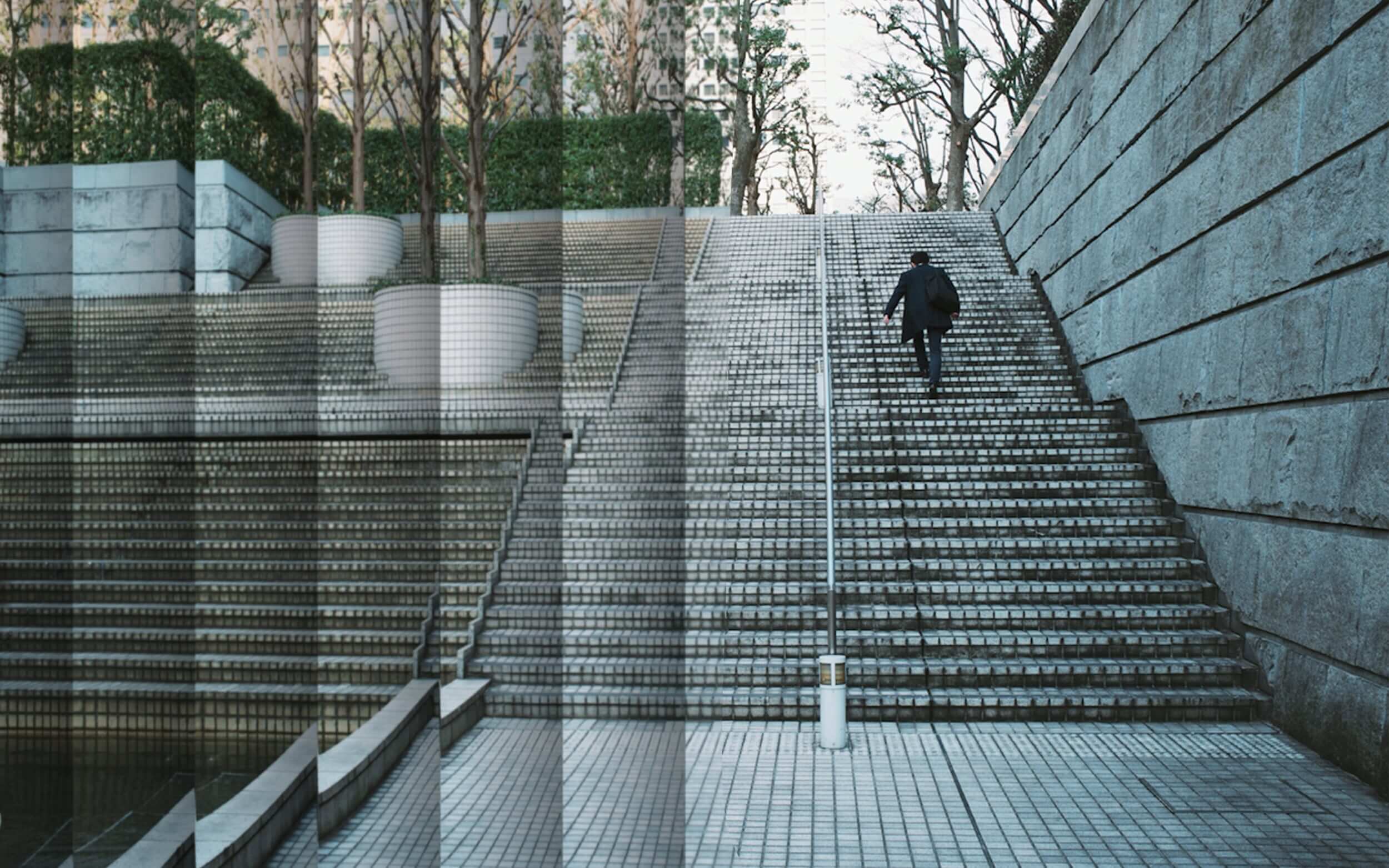 Image of man in suit climbing stairs; for decorative purposes only